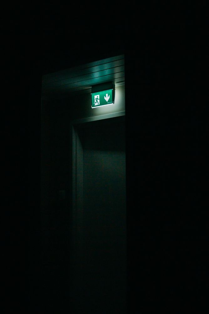 Glowing exit sign over doorway