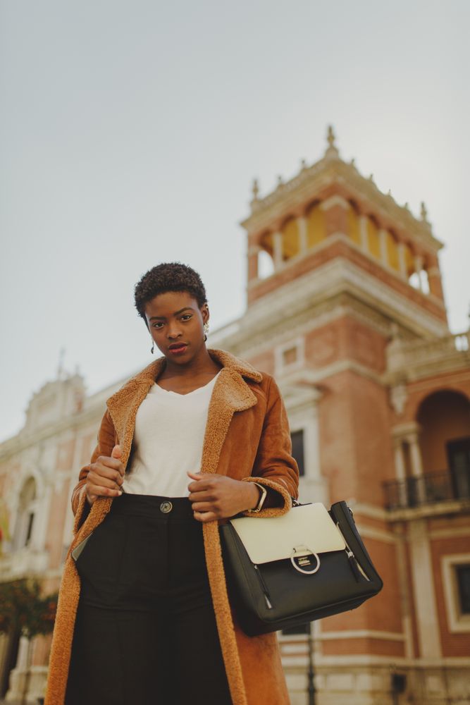 Stylish Black woman with handbag on street