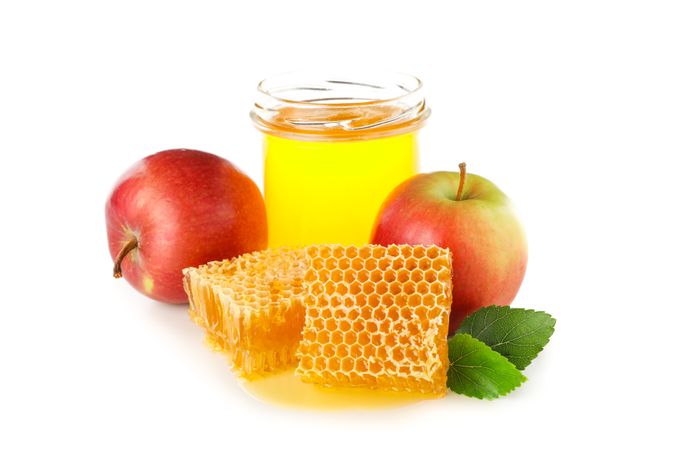 Pieces of honeycomb, apples and glass jar isolated on blank background
