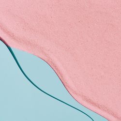 Pink sand and blue water beach scene