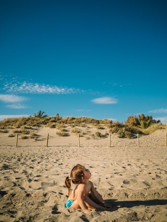 Girl playing on beach in sunny day