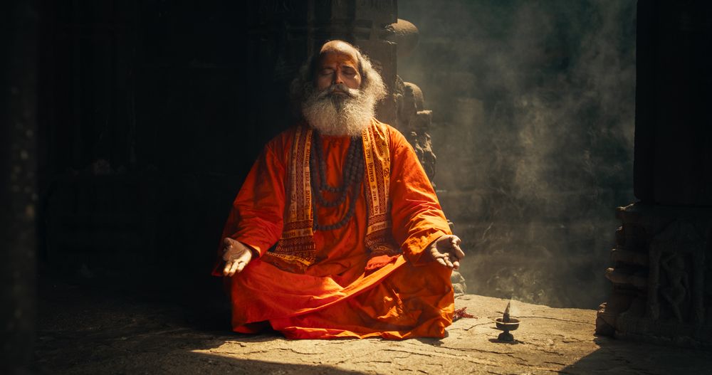 Portrait of a Mature Hindu Monk Looking at the Camera and Smiling in an Ancient Temple.