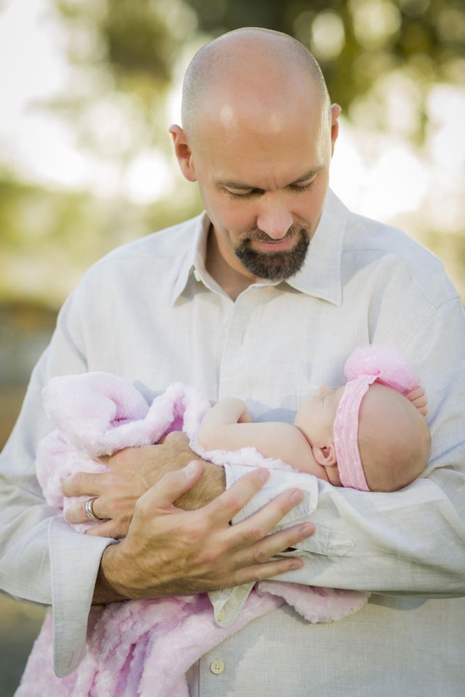 Father Holds His Newborn Baby Girl
