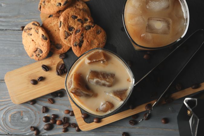 Composition with ice coffee and cookies on wooden background
