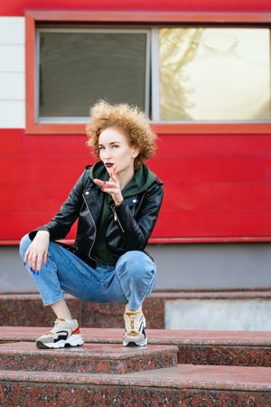 Curly haired female hipster outdoors
