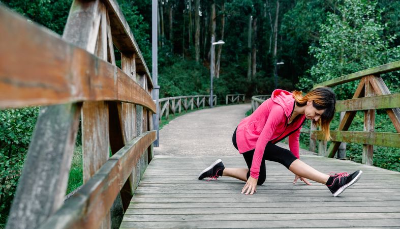 Athlete woman doing leg stretch
