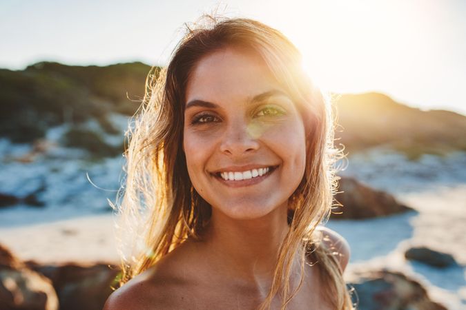 Happy female model on the beach