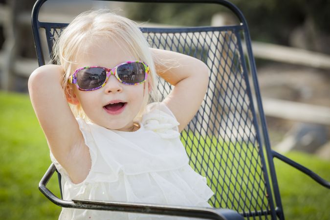 Cute Playful Baby Girl Wearing Sunglasses Outside at Park