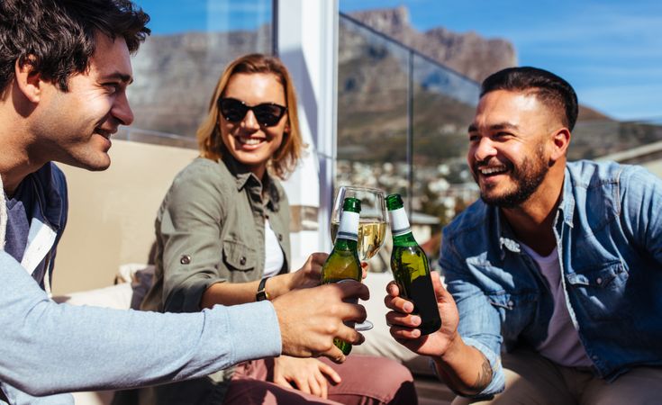 Millennial friends having beers at rooftop party