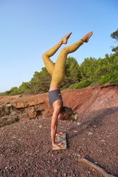 Sportswoman practicing yoga in nature
