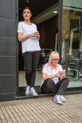 Two hairdressers on break outside of salon