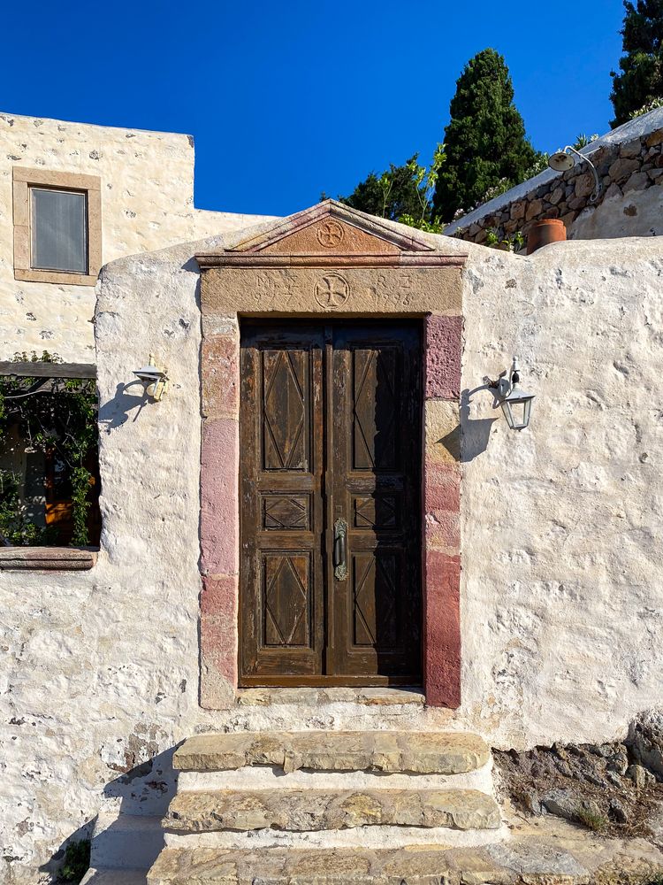 Patmian brown door with triangular arch