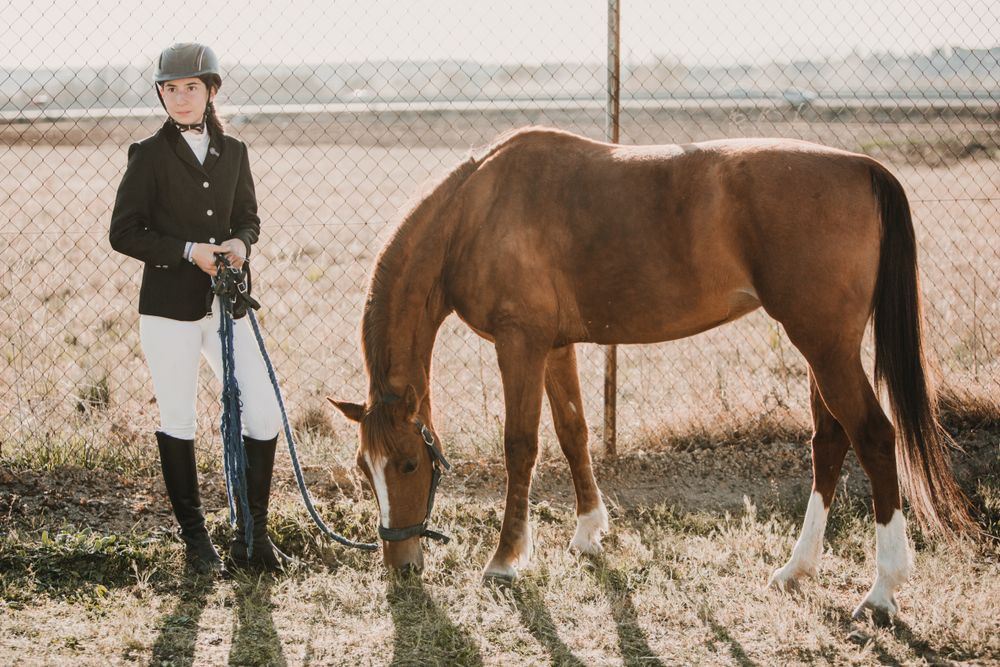Teen girl with horse on ranch