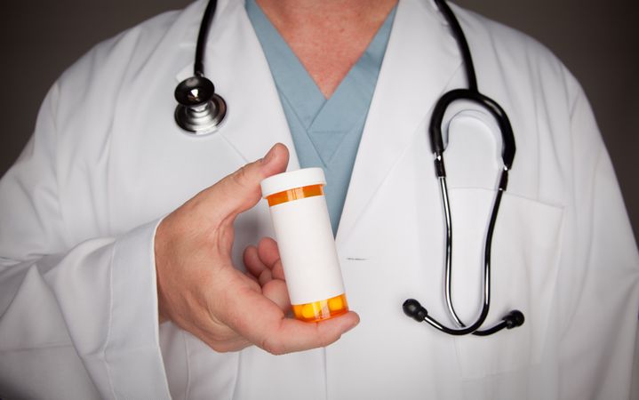 Male Doctor with Blank Medicine Bottle