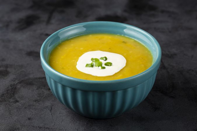 Bowl with pumpkin soup on the table.