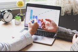 Two people discussing  statistics on business in an office