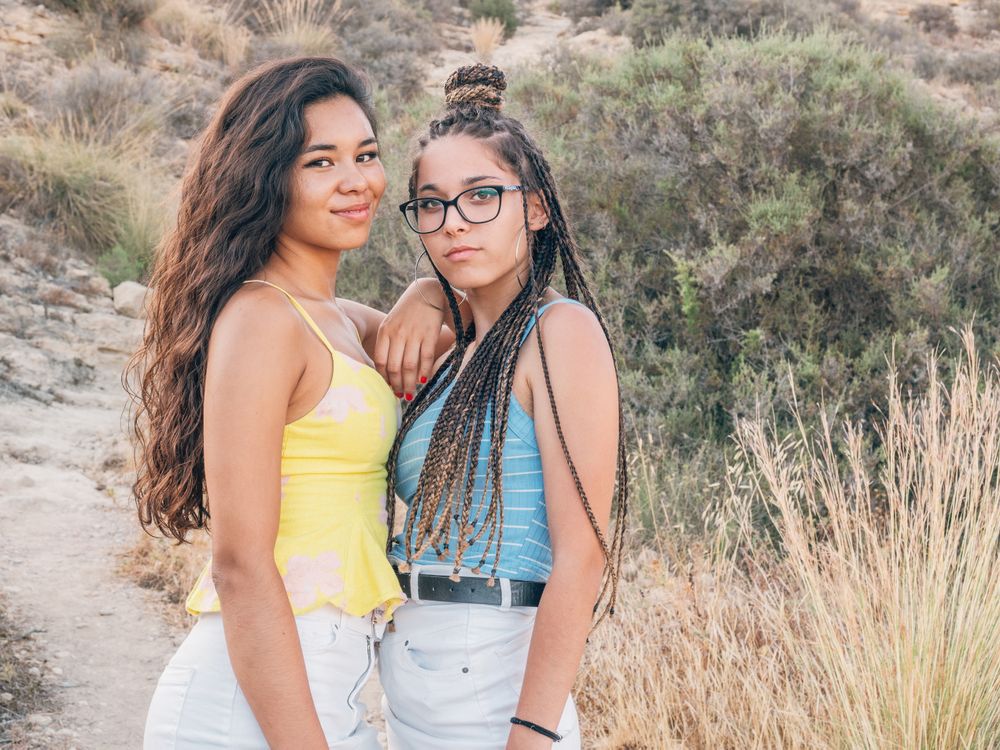 Happy trendy young women bonding at countryside