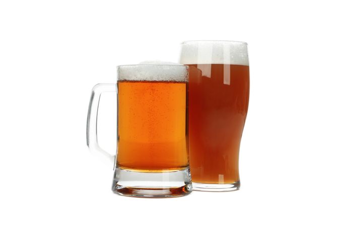 Glasses of beer isolated on light background