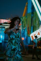 Woman in amusement park with sparkler