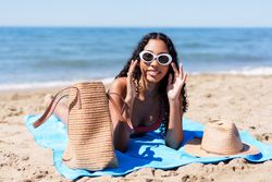 A Woman Enjoys a Relaxing Day on the Beach Surrounded by Stylish Accessories