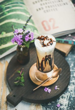 Latte in tall glass with chocolate syrup