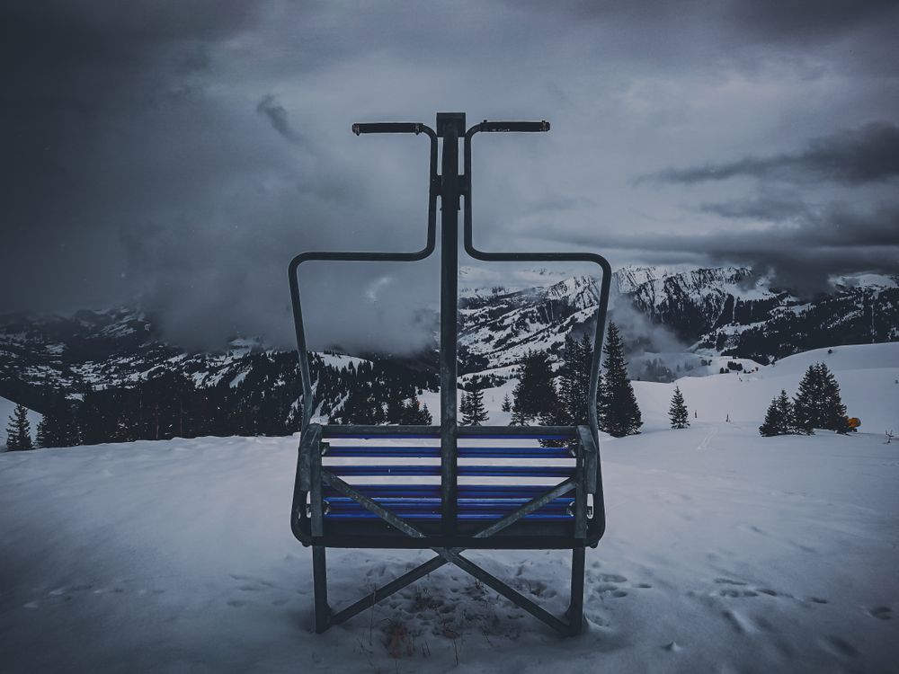 A lone and defunct ski lift at the edge of a slope, Videmanette Switzerland