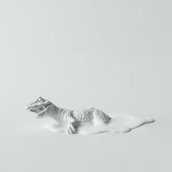 Painted dinosaur on light background