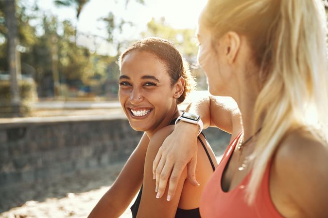 Woman smiling with her friend outside