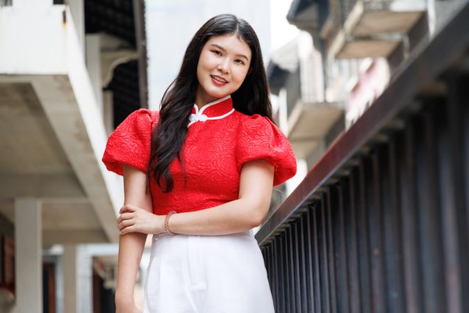 Portrait of Asian female in Chinese New Year shirt smile to camera