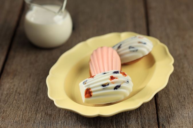 Beautiful Madeleine French Cake with Flower and Chocolate Coating.