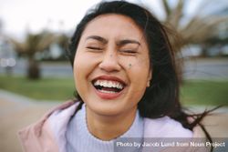 Close-up of young woman laughing with eyes closed 41pJZ5