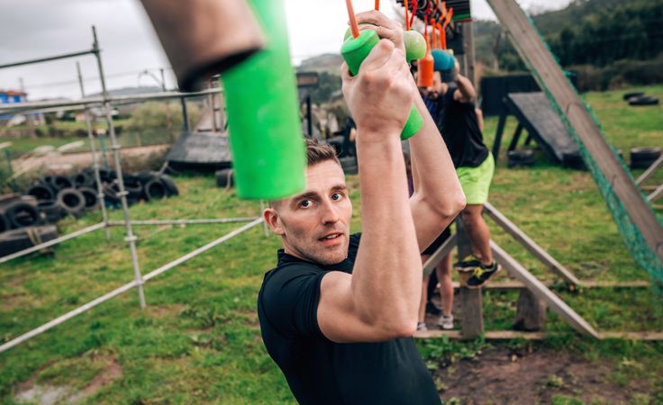 Participant obstacle course doing suspension