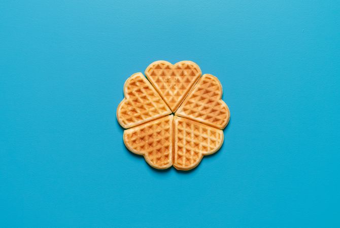 Homemade waffles top view, isolated on a blue background