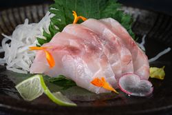 Appetizing sea bass sashimi with vegetables