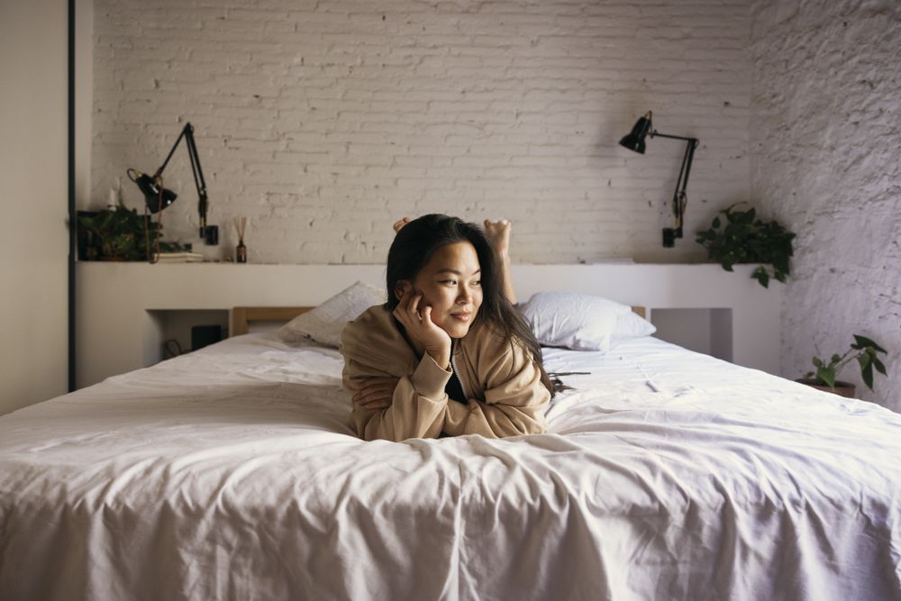 Portrait of young woman on bed