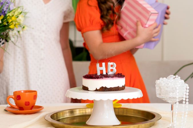 Young girl opening gift at birthday party