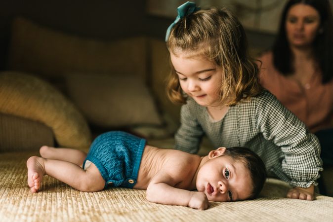 Little girl caring baby