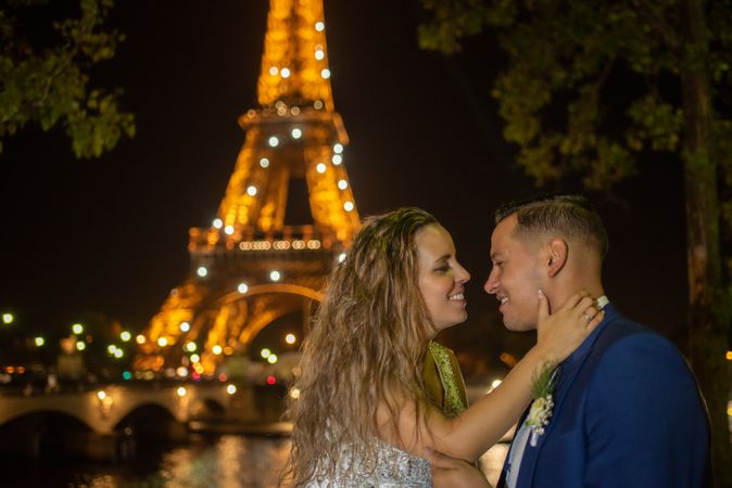 Overjoyed bridal pair enjoying in each other while kissing