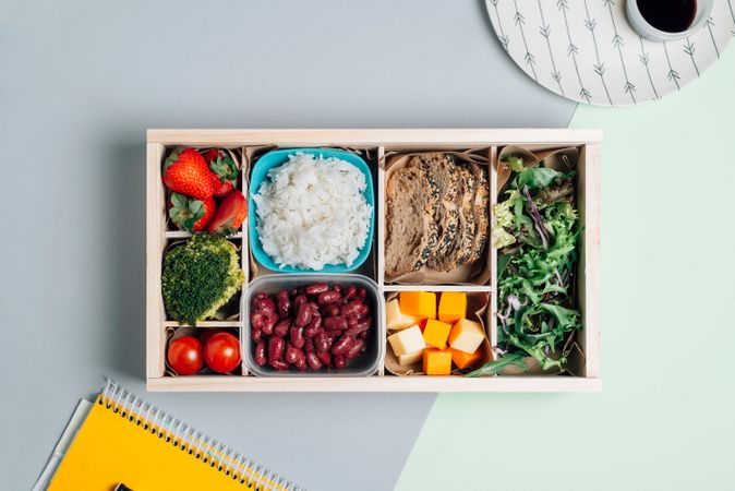 Food box with diet ingredients by copybook and plate