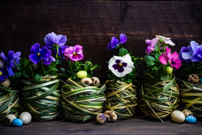 Easter holiday card concept with palms making pot for flowers and small eggs
