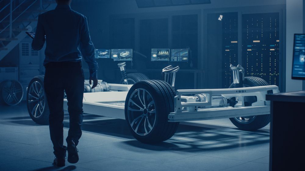 Automobile Engineer Enter Automotive Innovation Facility to Work on Electric Car Chassis Platform, Using Augmented Reality