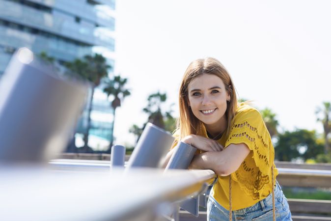 Young woman leaning handrail