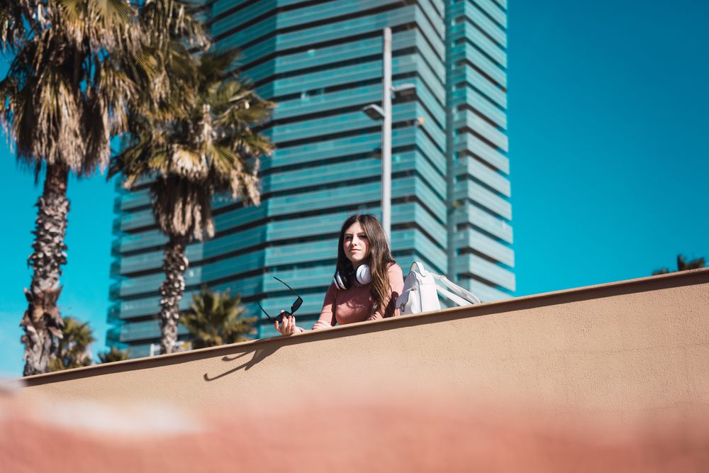 Teen girl watching the street while listening to music.