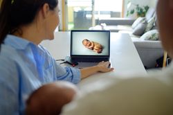 Parents sitting in front of a laptop computer