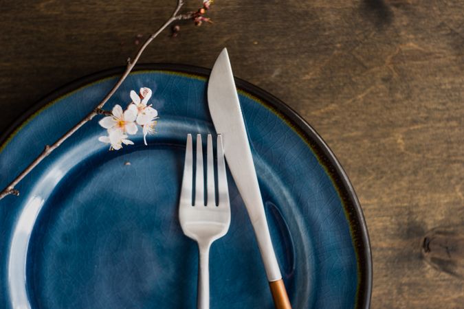 Spring table setting with blooming tree branch and cutlery with space for text
