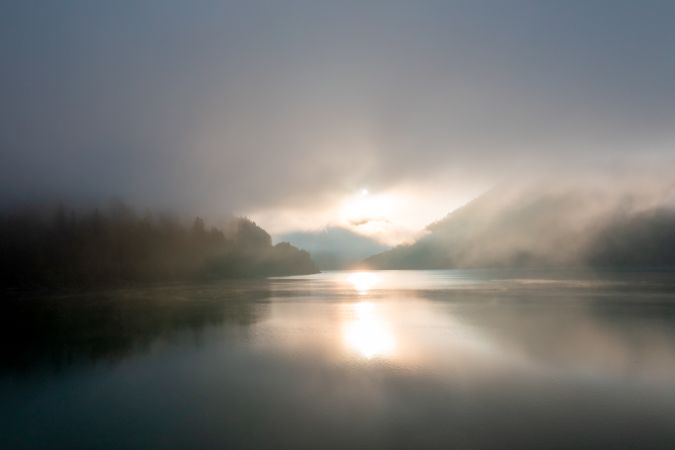 Drone image at sunrise with fog over Lake Sylvenstein in Upper Bavaria region, Germany