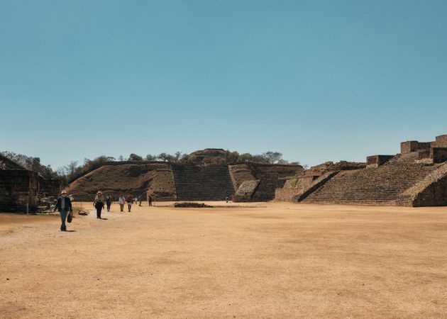 People walking among ancient Zapotec ruins in Mexico