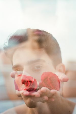 Young man with red flowers