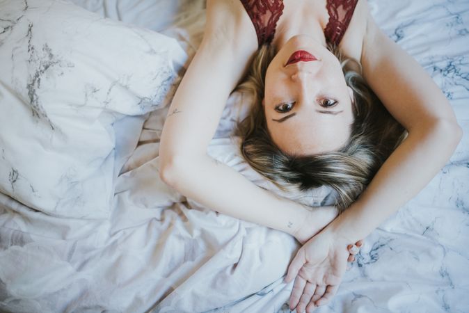 Woman lying in bed at home