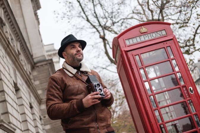 Male photographer near red telephone box